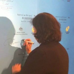 Signing the station's wall        